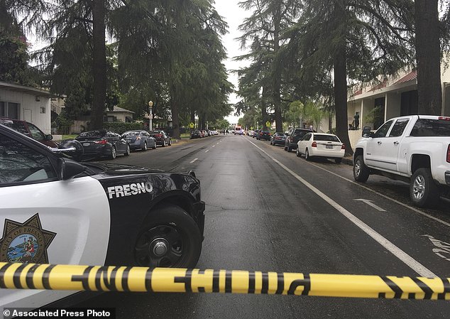 A street is blocked off where emergency officials say a shooting has killed one person and injured two others after screaming 'god is great' in Arabic