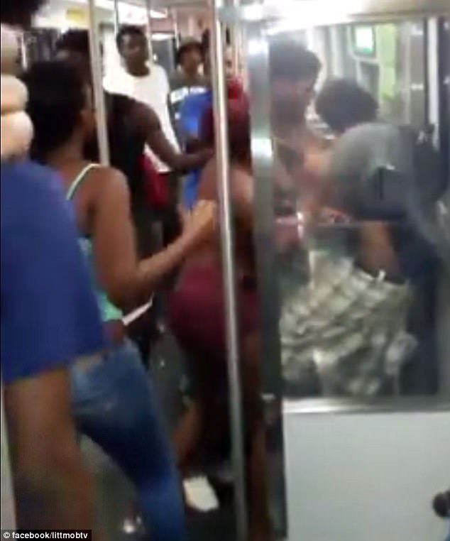 The group pushed Kennan Jones (right in checked shorts) against the train doors to beat him 