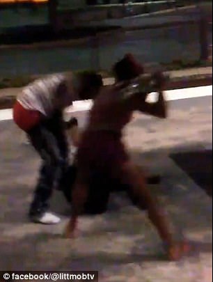 One of the young women in the group hit the man in the head with a skateboard as he lay lying on the ground