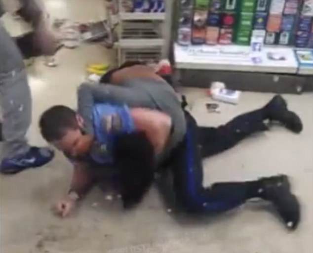 The officer slams the woman to the ground but she fights back hard